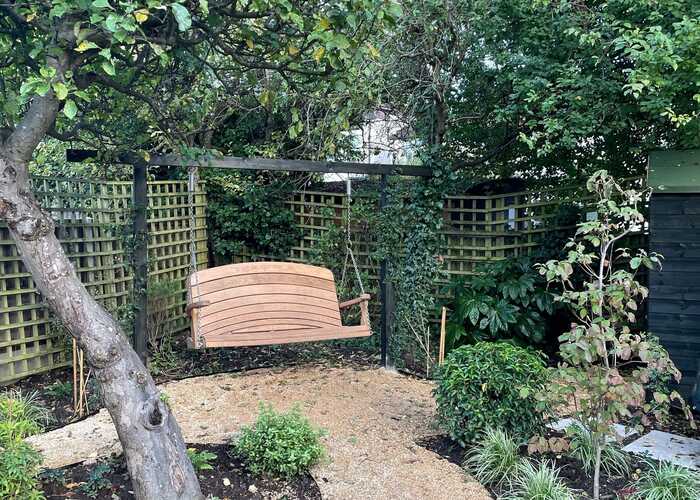 Goalpost Pergola with swing seat in garden - Designed by Clarissa Judd